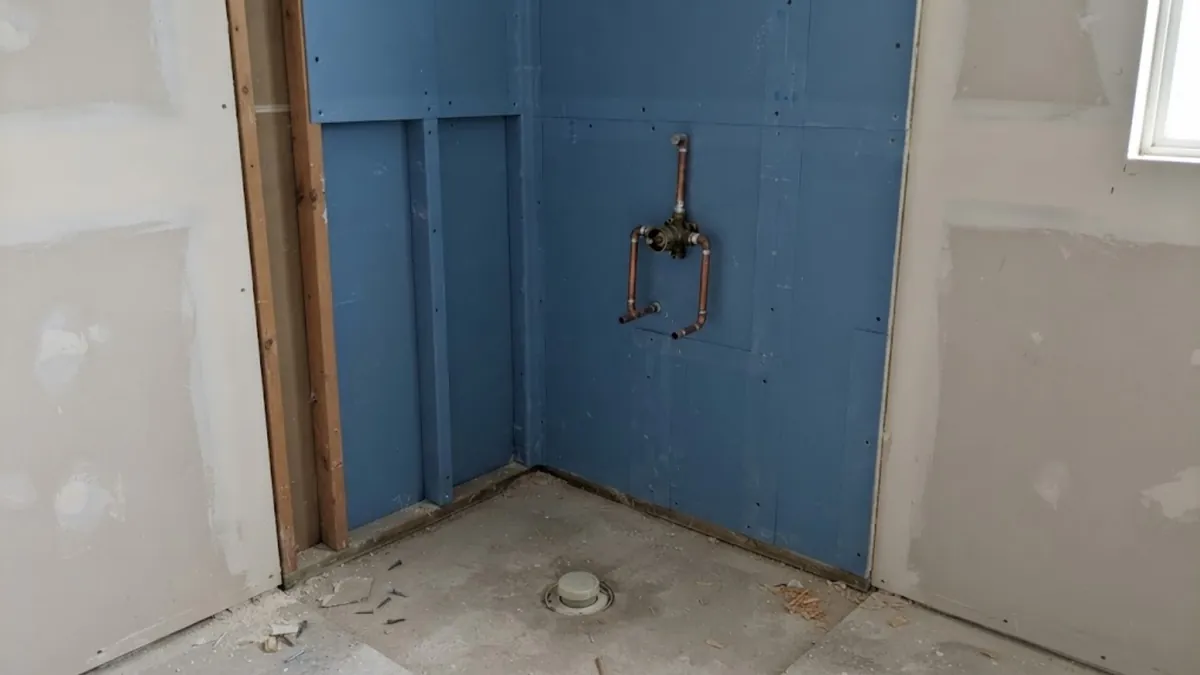 Shower valve rough-in and waterproofing membrane during a shower installation in Mission Viejo
