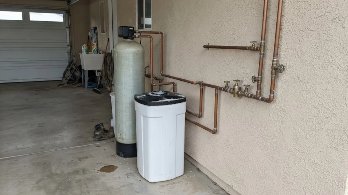 Water softener and brine tank installed in a garage to treat hard water in Mission Viejo
